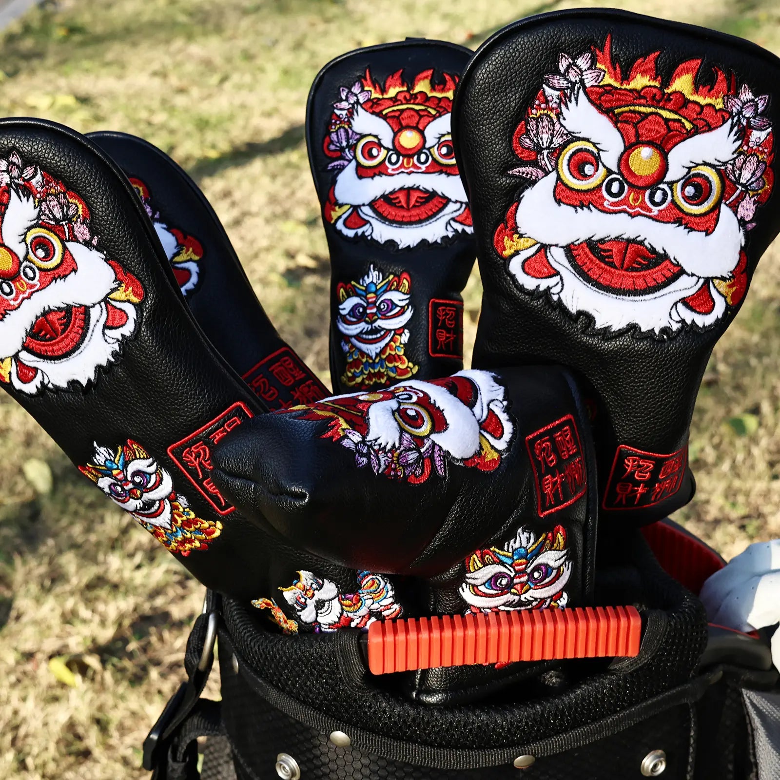 Yamato black lion golf head covers displayed on golf course outdoors