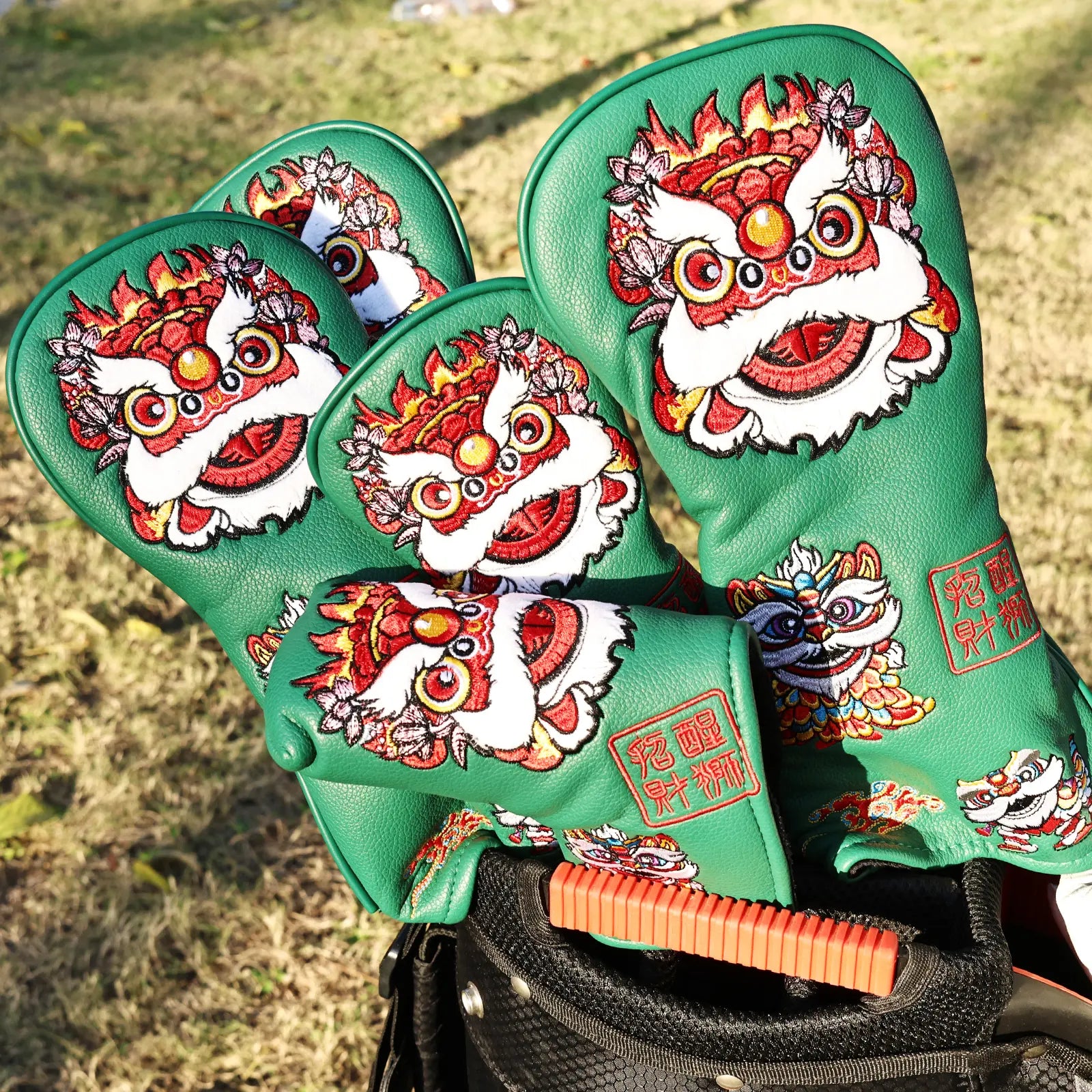 Yamato green lion golf head covers displayed on golf course outdoors