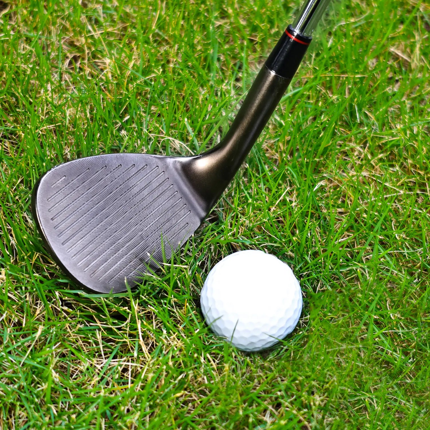 Golfer using Yamato wedge on green grass for a high-spin approach.
